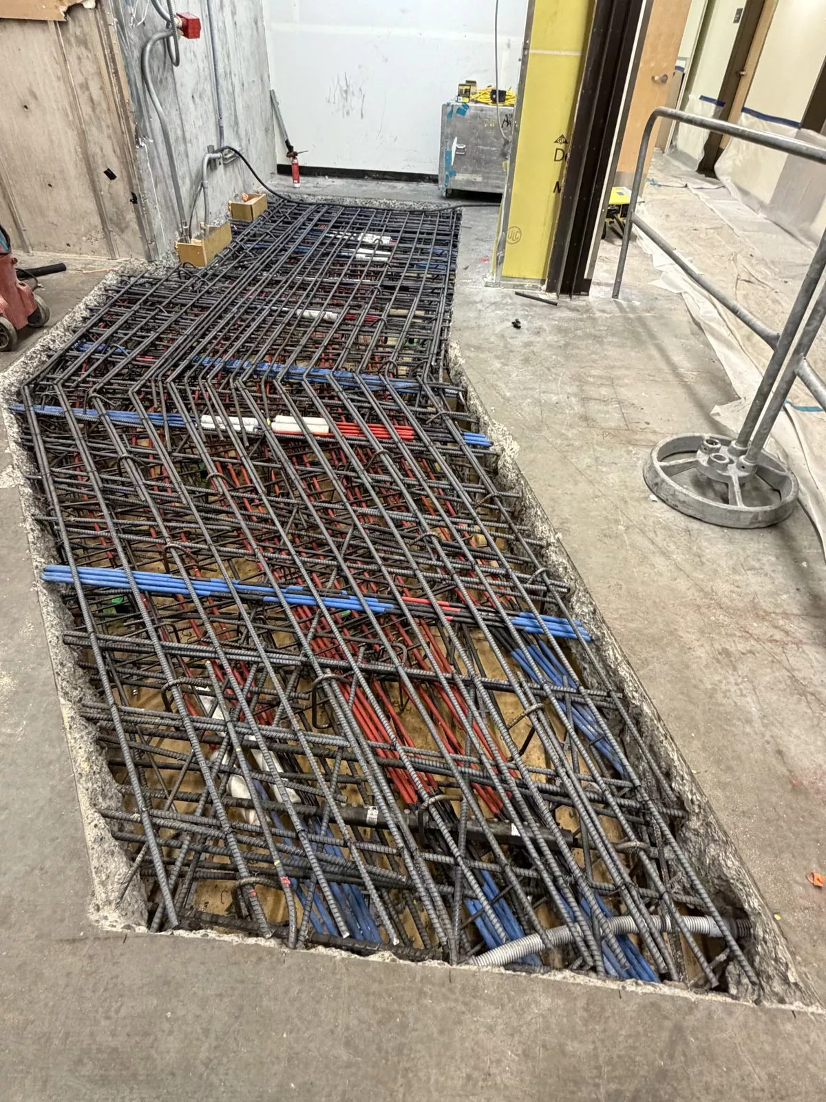 Opening cut in a post-tensioned slab with tendons and rebar reworked